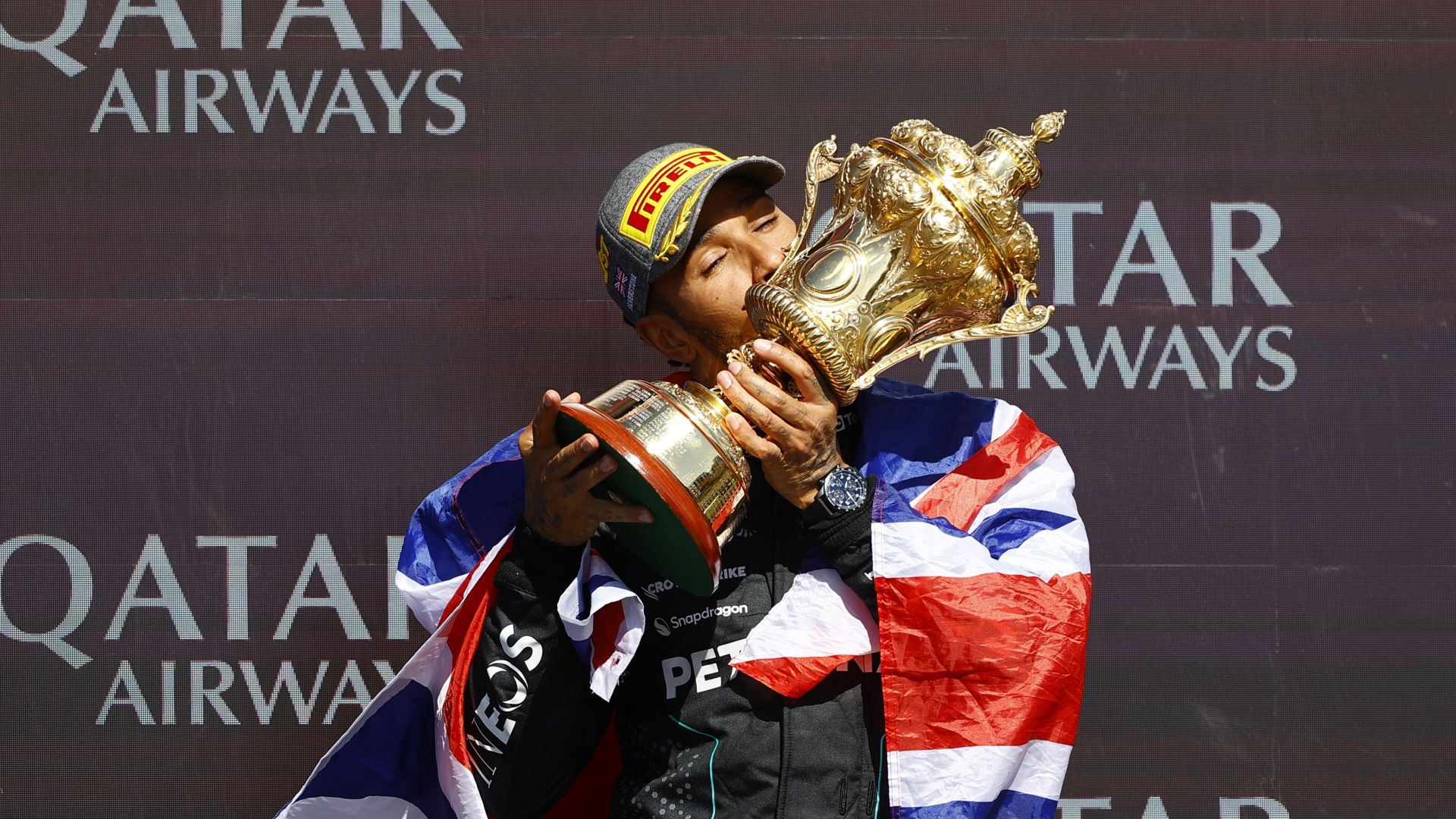 SILVERSTONE CIRCUIT, UNITED KINGDOM - JULY 07: Sir Lewis Hamilton, Mercedes-AMG F1 Team, 1st position, kisses the winners trophy during the British GP at Silverstone Circuit on Sunday July 07, 2024 in Northamptonshire, United Kingdom. (Photo by Andy Hone / LAT Images)
